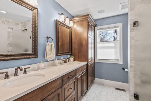 Private three-quarter bathroom with a walk-in shower featuring dual shower heads.