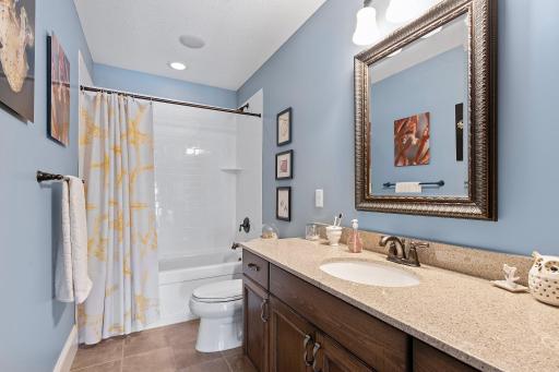 Upper level shared bathroom with a jetted soaker tub.