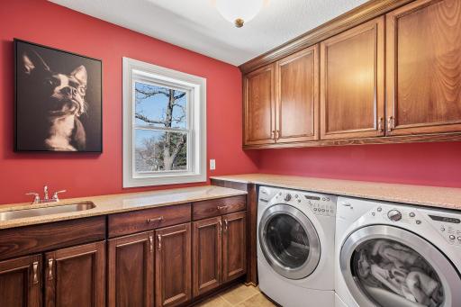 Completing the upper level is a convenient upper level laundry room with sink, cabinetry, and countertops.