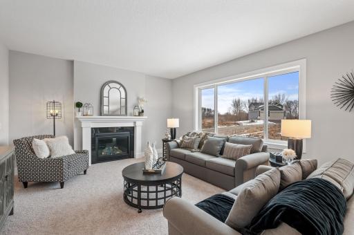 The living room features a cozy gas fireplace to gather around.