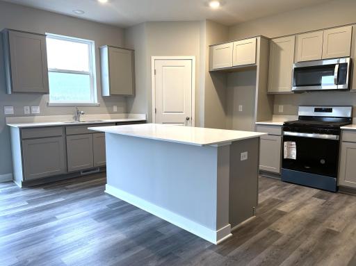 *This photo is not of the ACTUAL home for sale. This is a photo showing the change from granite to quartz countertops. Notice the beautiful quartz counter tops!