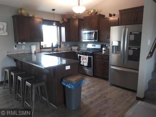 Clean kitchen with stone countertops. Stainless appliances