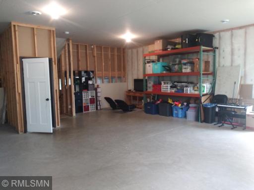 10 foot ceilings in this 3rd level walk out for your family room/game room options! Racking storage is negotiable.