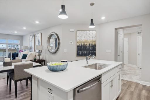 (Photo of a decorated model, actual homes finishes will vary) The main level seamlessly transitions from room to room while maintaining an open-concept layout throughout.