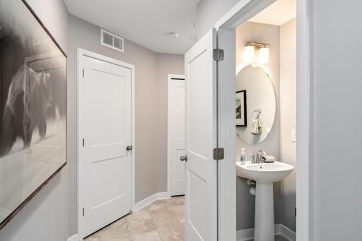 (Photo of a decorated model, actual homes finishes will vary) Conveniently located powder bath off the main level.
