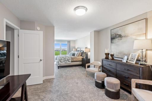 (Photo of a decorated model, actual homes finishes will vary) Extremely spacious and elegant, this private owner’s suite connects to a en-suite bath providing a great oasis to relax in your own private space in addition to a large walk-in closet.