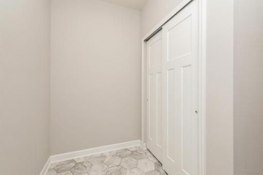 Mudroom with spacious closet located right off the kitchen.