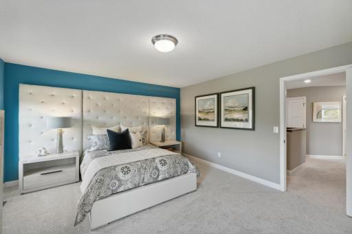(*Photo of decorated model, actual homes finishes and colors will vary) Extremely spacious and elegant, this private owner’s suite connects to a large en-suite bath providing a great oasis to relax in your own private space.