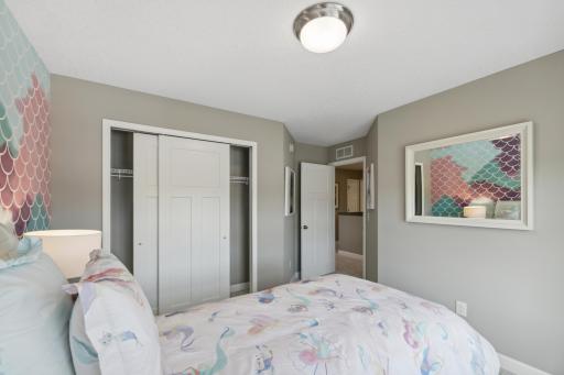(*Photo of decorated model, actual homes finishes and colors will vary) One of three generously sized secondary bedrooms with a spacious closet!