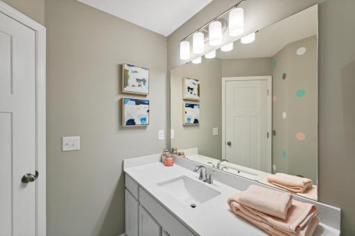(*Photo of decorated model, actual homes finishes and colors will vary) The spacious main level bath provides plenty of space for everyone to get ready during those busy mornings.