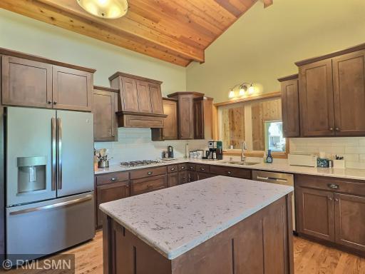 Custom cabinets, island, gorgeous countertops and vaulted ceiling complete the gorgeous updated kitchen.