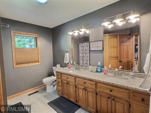 Conveniently next to both lower level bedrooms is an updated full bathroom with tile flooring and double sinks.