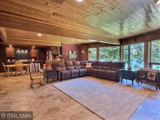 Bring the party to the lower level walk-out offering tile flooring and lake views from a wall of windows.