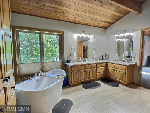 Another view of the completely remodeled primary bathroom offering a glass shower and double sink vanity.