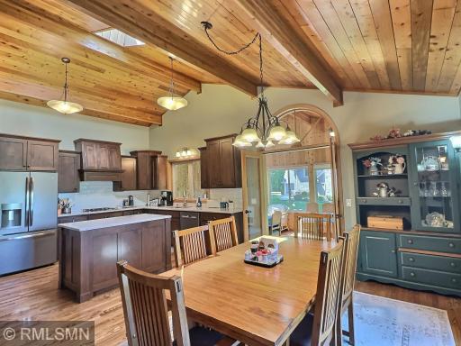 The kitchen opens to the dining room offering Oak floors, vaulted ceilings a door to lakeside wrap-around deck.