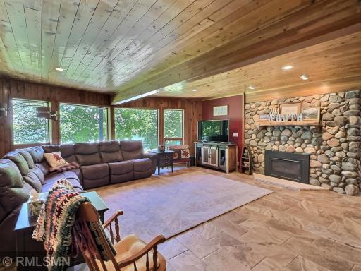 Another view of the lower level family room that can be warmed from the gas fireplace with rock accents.