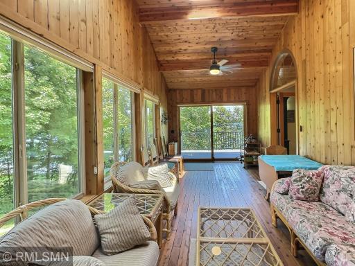 Relax and enjoy the sunlight, 3-season porch offers cedar wood, ceiling fan and a summer kitchen with a sink.