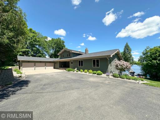 A beautiful entrance year-round, drive into privacy and seclusion with mature trees and an asphalt driveway.