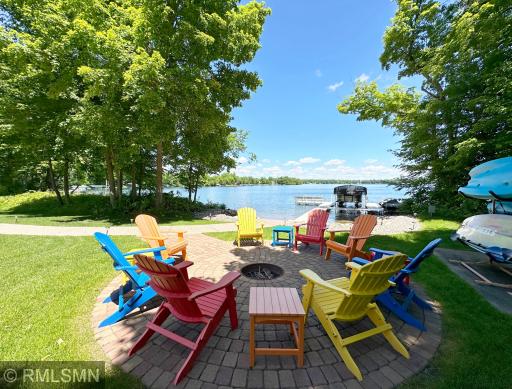A winding sidewalk leads to the built-in fire pit and 154 feet of sandy hard bottom lakeshore...the perfect spot to enjoy lake life!