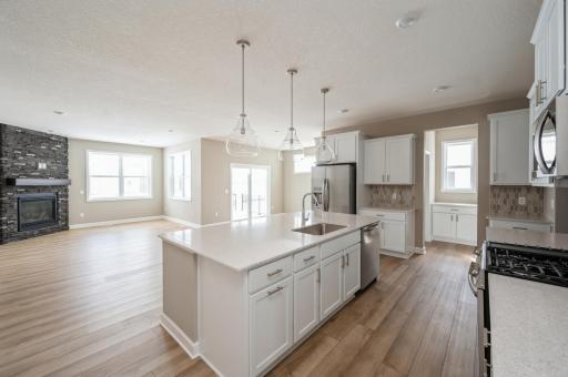 (*Photo of similar home, actual homes colors and finishes will vary) Enjoy plenty of seating at the kitchen island and dining area adjacent to the kitchen.