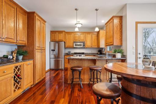 Beautiful kitchen, natural woodwork, stainless steel appliances, granite countertop. See all that storage!