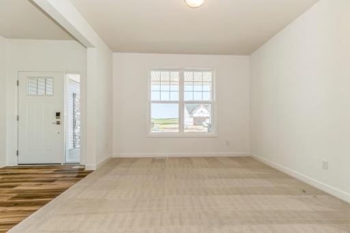 Photo is of the actual home. The main level flex room provides a perfect setting for those working from home, paying bills or completing a school project.