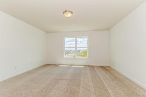 Photo is of the actual home. Find your retreat in this stunning primary bedroom. Enjoy the exclusivity of a private bath and huge walk-in closet.