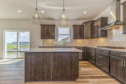 Photo is of the actual home. Soaked in natural sunlight, the homes eat-in dining room has ample space for a dining table located in the heart of the home.