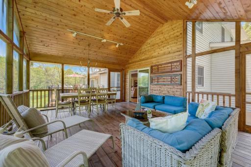Large stunning 3 season porch with vaulted ceilings comfortably allows multiple people to gather and eat or lounge in a tranquil setting with a gentle breeze
