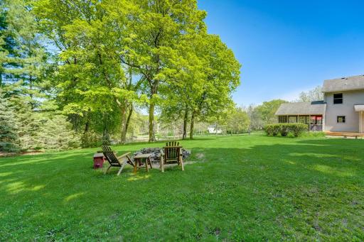 Enjoy the peaceful backyard around the fire while overlooking the pond and natural sidewoods