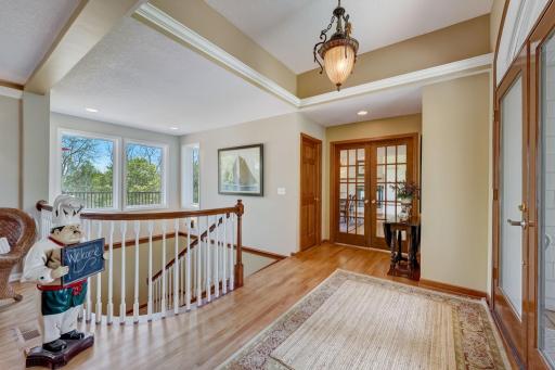Bright Large Foyer and Open Floor Plan with Hardwood Flooring & Custom Curved Stair Railing