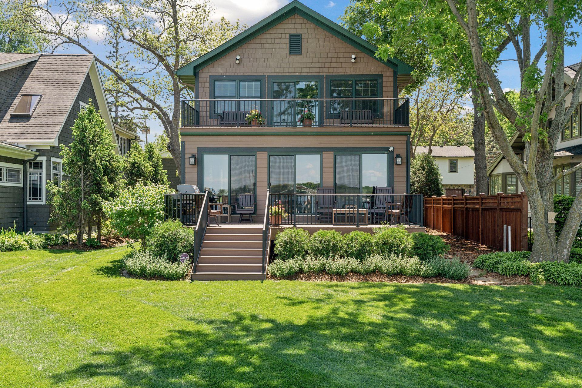 lakeside of home, 2 new composite decks and walls of windows for sunrise views