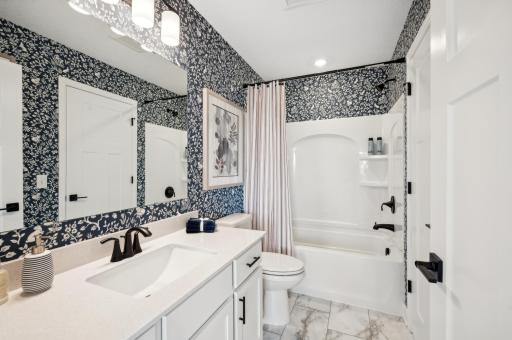The main floor bathroom connects to the main hallway and owner's suite for added convenience