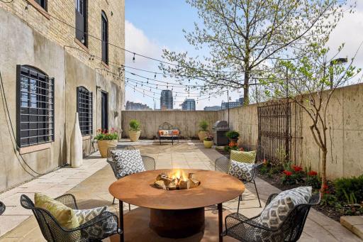 Welcome home to this luxurious Mill City loft-style condo with its own private entrance and patio. You and your guests will absolutely love the guest parking next to the patio!