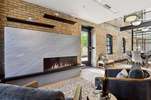 Step inside to the Hearth Room. The renovations maintain the integrity of the original building while providing updates for modern living like this contemporary fireplace. Notice how its detailing echoes the original brick and metal work.