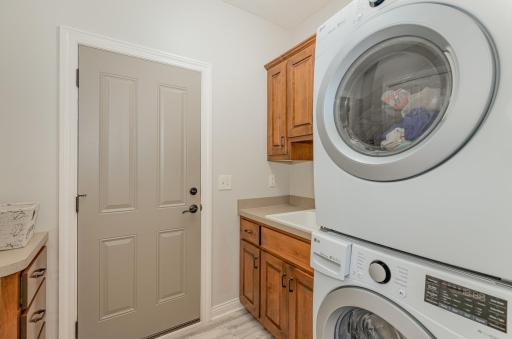 Convenience is key with an in-unit washer/dryer and sizeable laundry room complete with washtub and plenty of cabinets for storage.