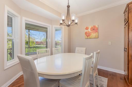 The dining area positioned strategically near the kitchen ensures convenience and ease of serving. Large windows allow natural light to fill the room, creating a bright and inviting atmosphere.
