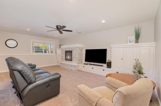 Downstairs, a large lower level finished family room complete with this cozy gas fireplace with stone finishing adds a touch of warmth and ambiance to the room.