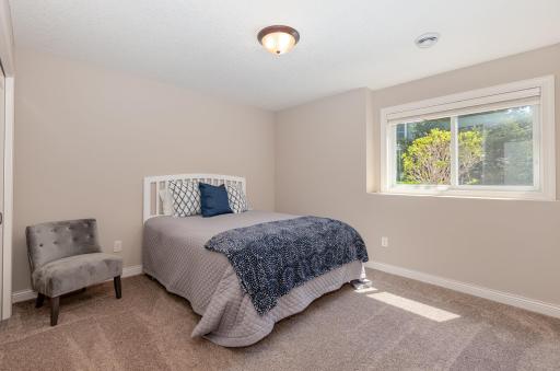 The second of the three bedrooms in the lower level offers comfort and privacy for its occupants. With ample space and thoughtful design, it provides a cozy retreat for relaxation or restful sleep.