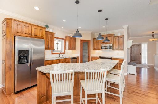 The heart of the home is the eat-in kitchen complete with stainless steel appliances, ceiling canister lighting and pendant lighting over center island.
