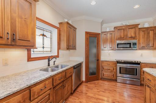 Contemporary custom cabinetry and granite countertops with stunning cherry hardwood floors brings a feel of warmth to you life.