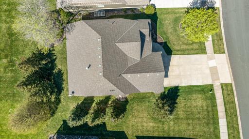 From an aerial perspective, the home is a captivating sight. Nestled within a landscape of greenery, the property stands out with its distinct features.