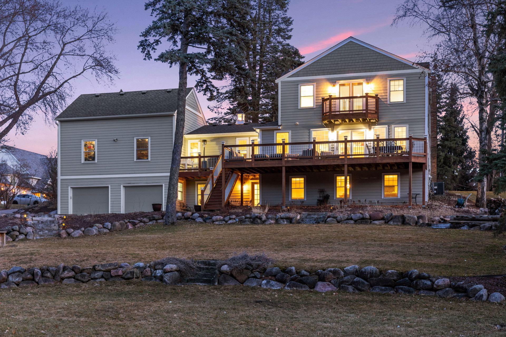 A tiered stone wall system was installed to create layers to this double lot leading to the pond and wetlands.