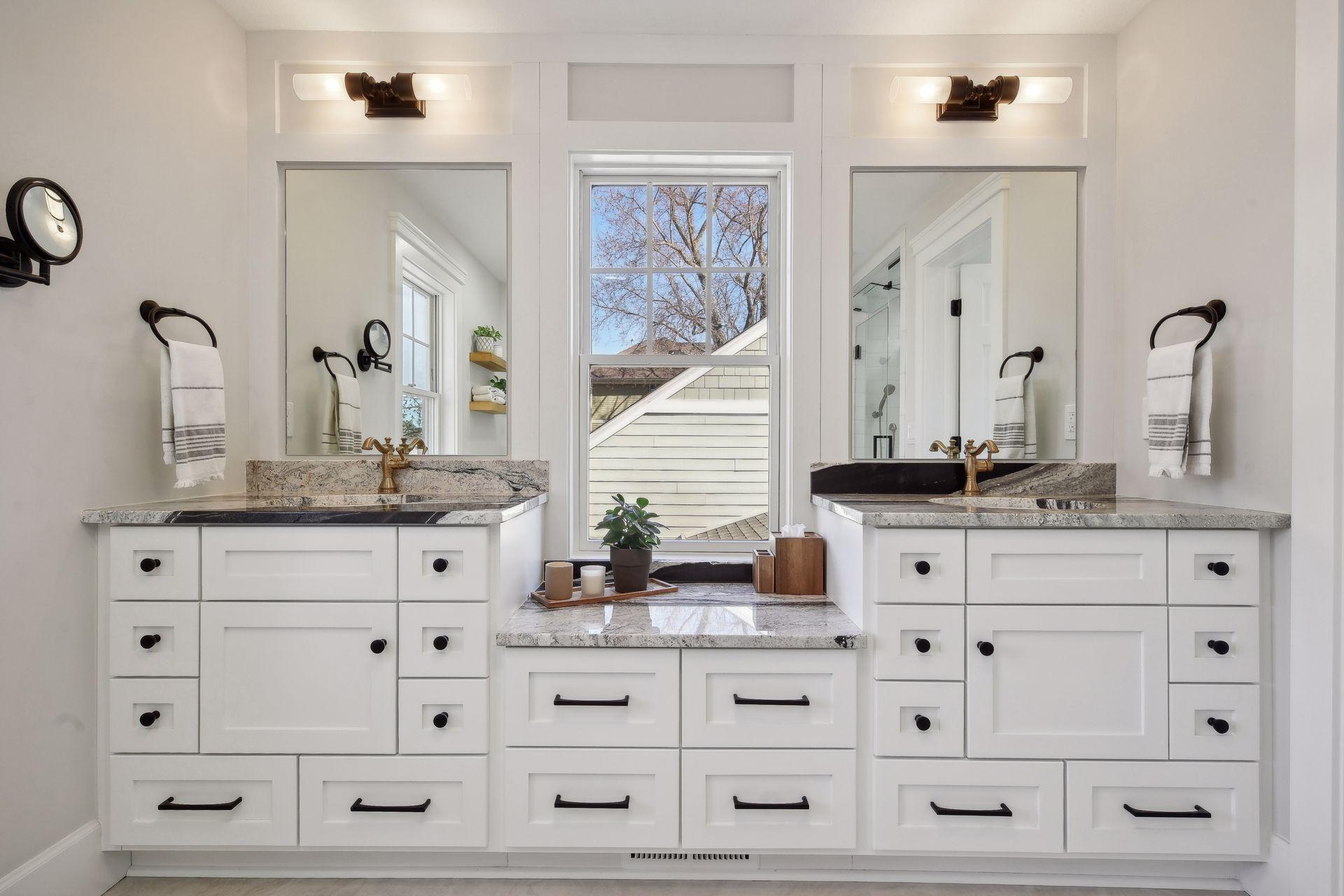 Beautifully renovated primary bathroom with ample storage and high end finishes.