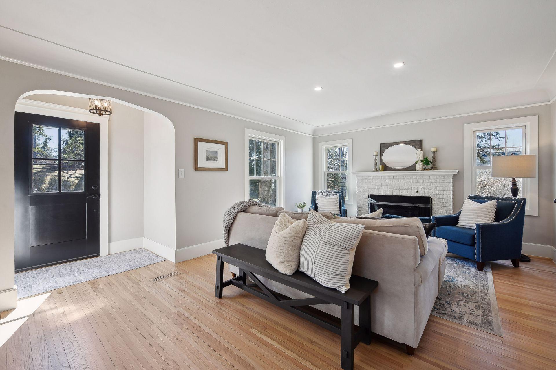 The front living room is centered by a beautiful new gas fireplace a gorgeous surround and mantel