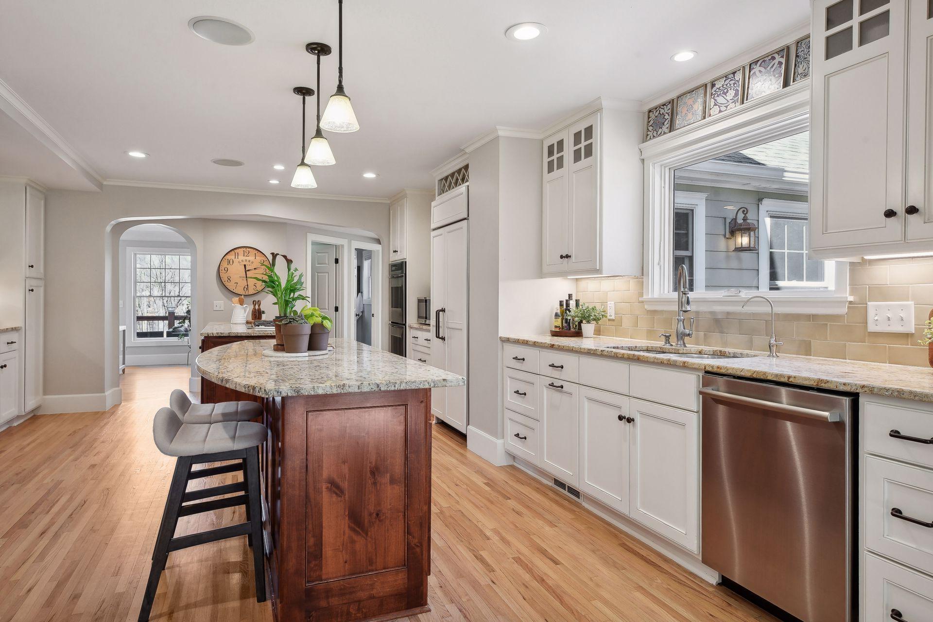 A double island design, floor to ceiling custom cabinetry and an expansive seating area at the island will impress.