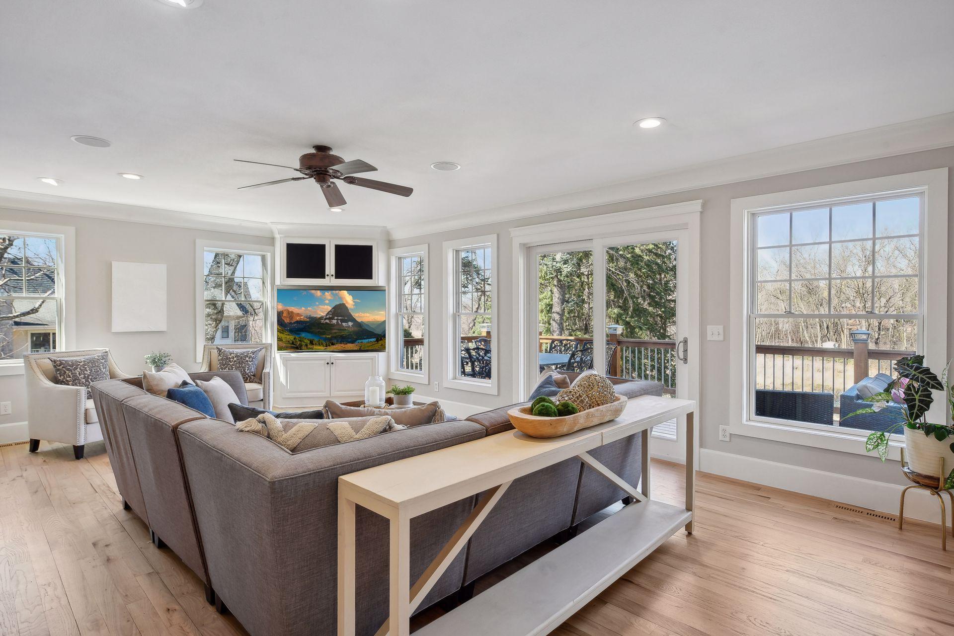 The main level family room overlooking this stunning landscaped double lot with a pond is the perfect gathering spot.
