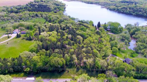 The lot sits perched above the road giving the feel of overlooking the surrounding area. With the clearing some additional trees bring the river and Lake Caroline into your views.