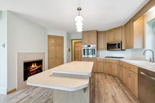 The 2 sided fireplace & heated floors adds a lovely ambiance. The corner pantry, island drawers & numerous cabinetry adds tons of storage,