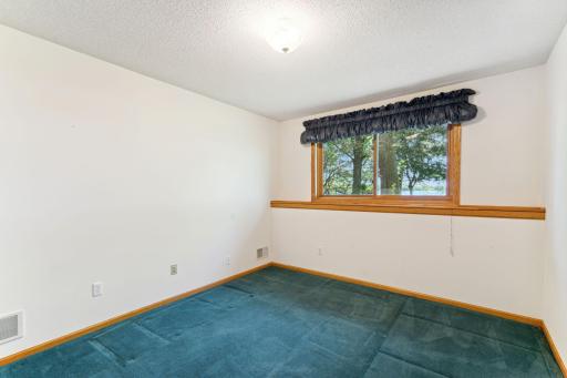 Lower level - 3rd Bedroom features large closet with double doors & lakeside views.